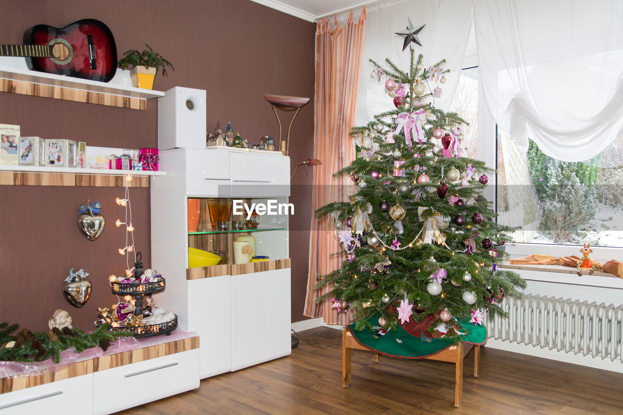 Christmas tree on hardwood floor at home