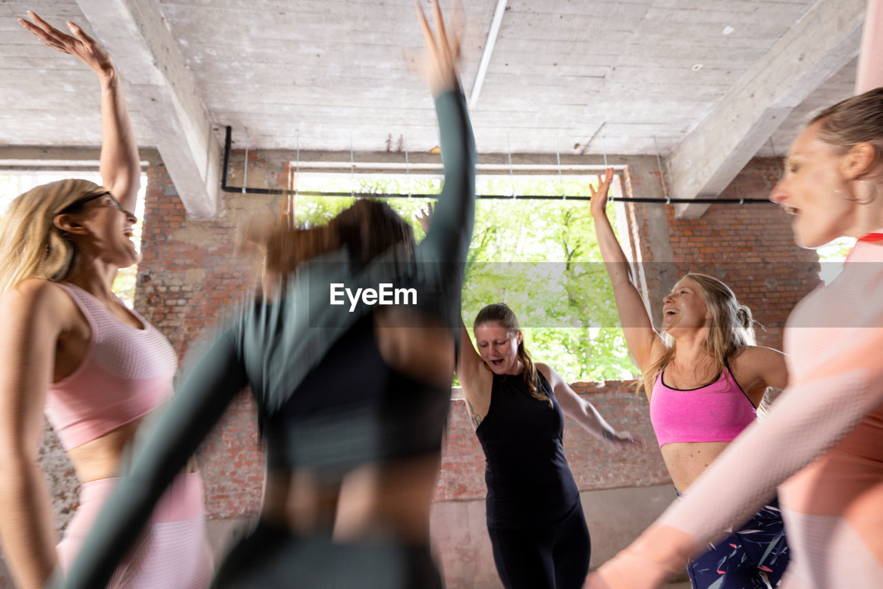 side view of young woman exercising at gym