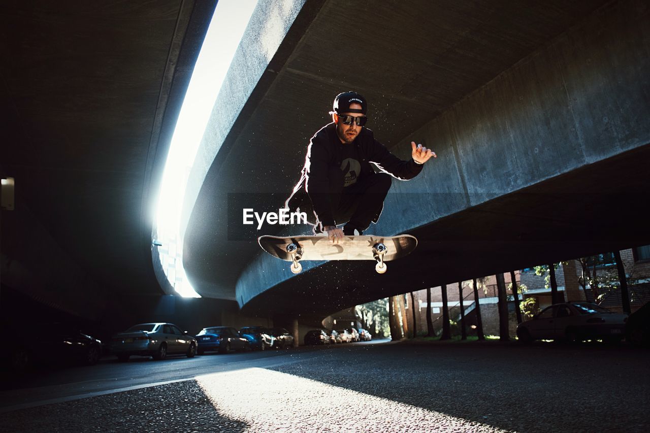 Low angle view of man jumping on skateboard