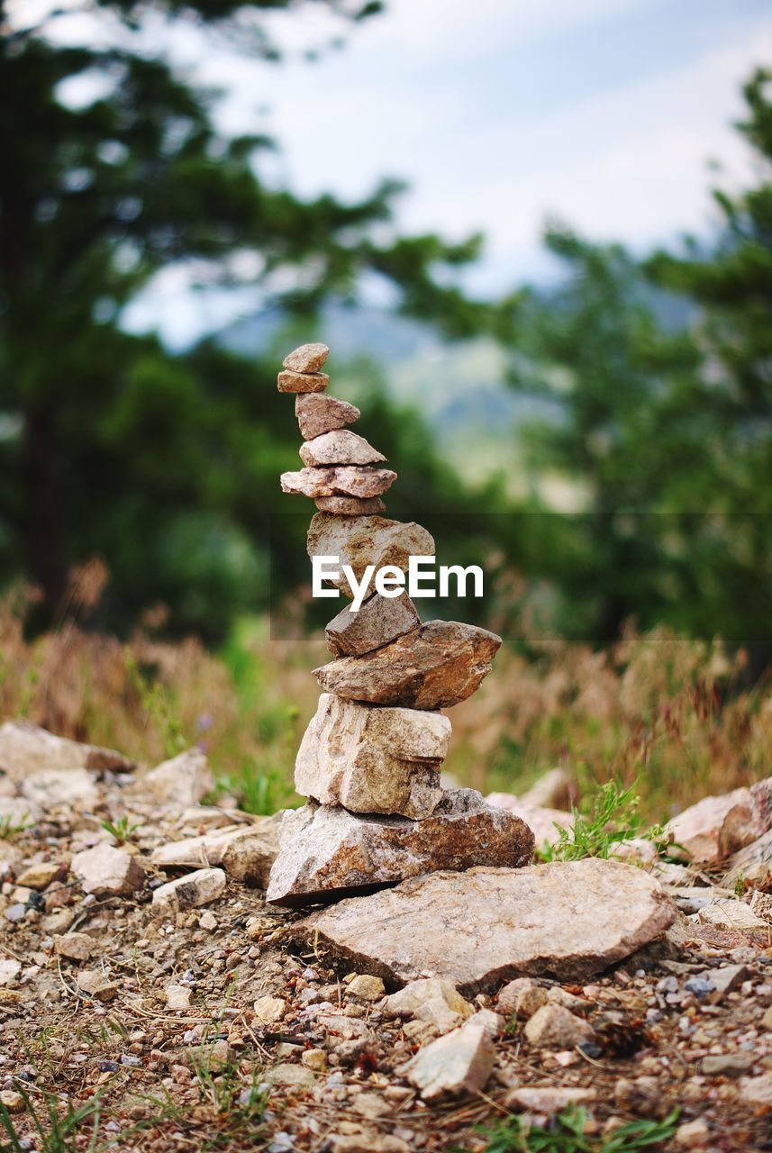 Stack of stones balancing on field