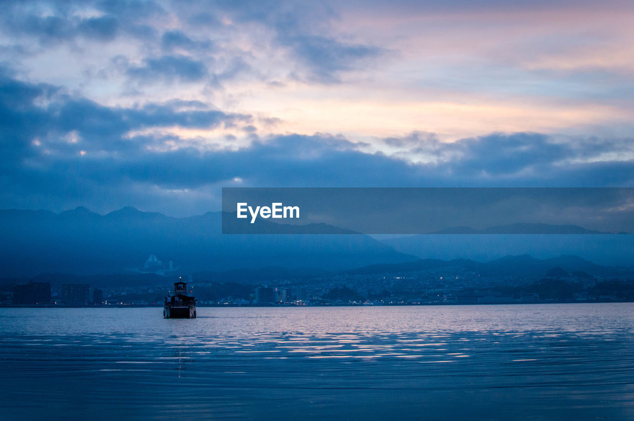 Scenic view of lake against cloudy sky 