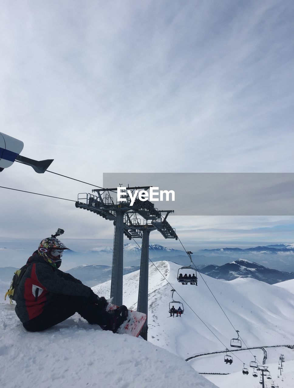 SKI LIFT ON SNOWCAPPED MOUNTAIN AGAINST SKY