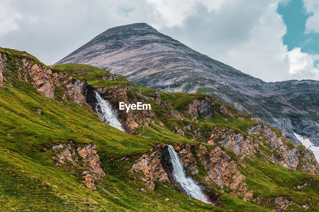 Low angle view of waterfall against sky