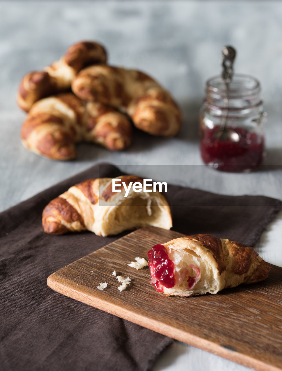 Close-up of croissants and jam on table
