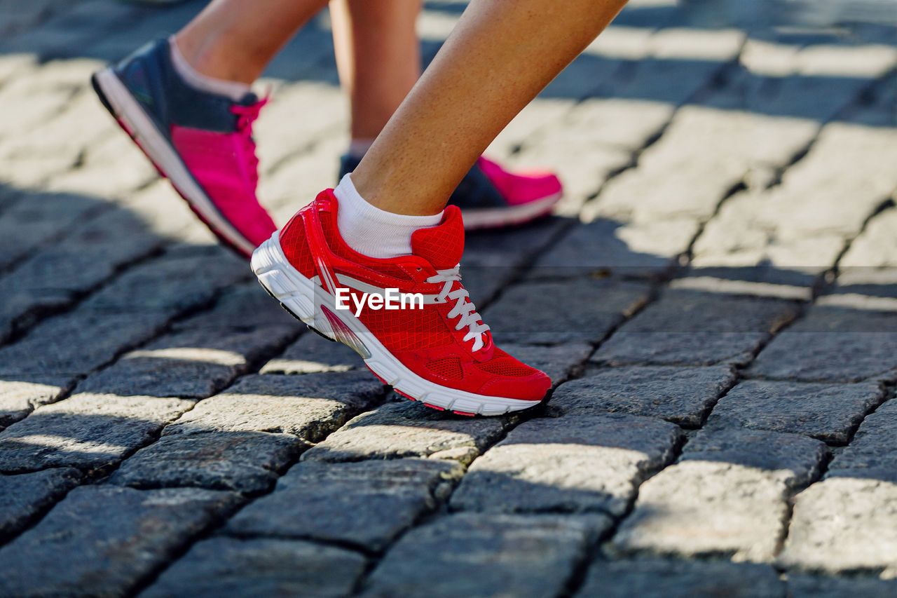 Legs two runner girls in running shoes