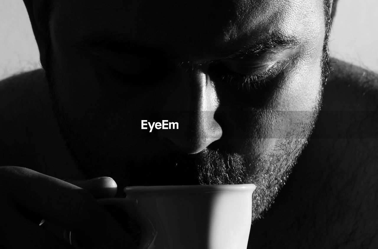 Close-up of mid adult man drinking coffee