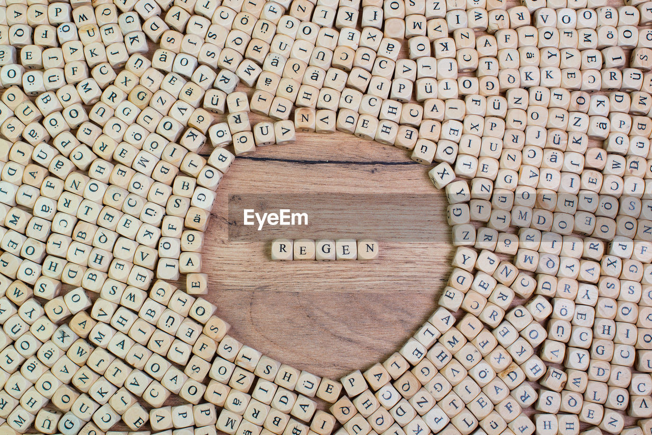 High angle view of alphabets on blocks at wooden table