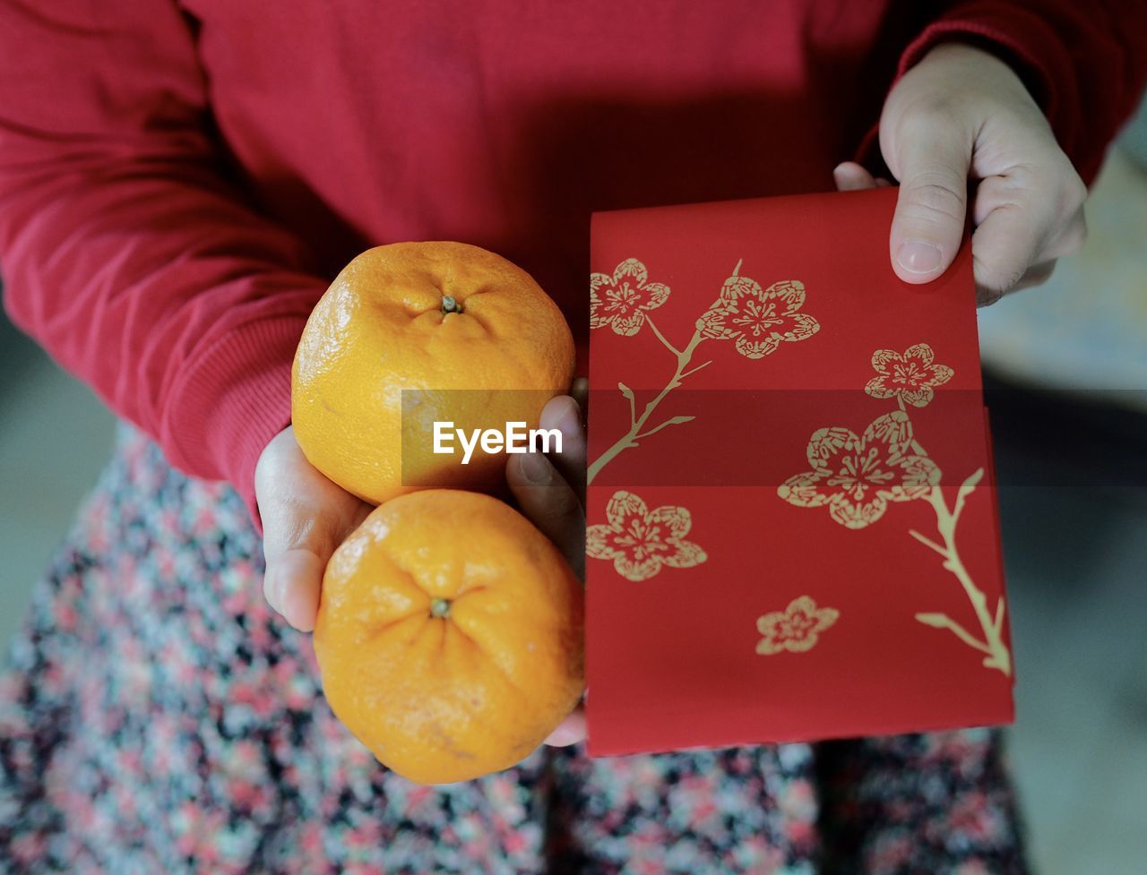 Close-up of hand holding orange