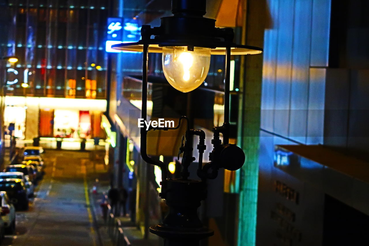 CLOSE-UP OF ILLUMINATED LIGHT BULB HANGING