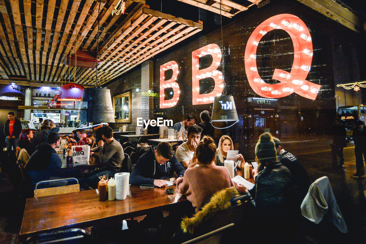 GROUP OF PEOPLE AT RESTAURANT