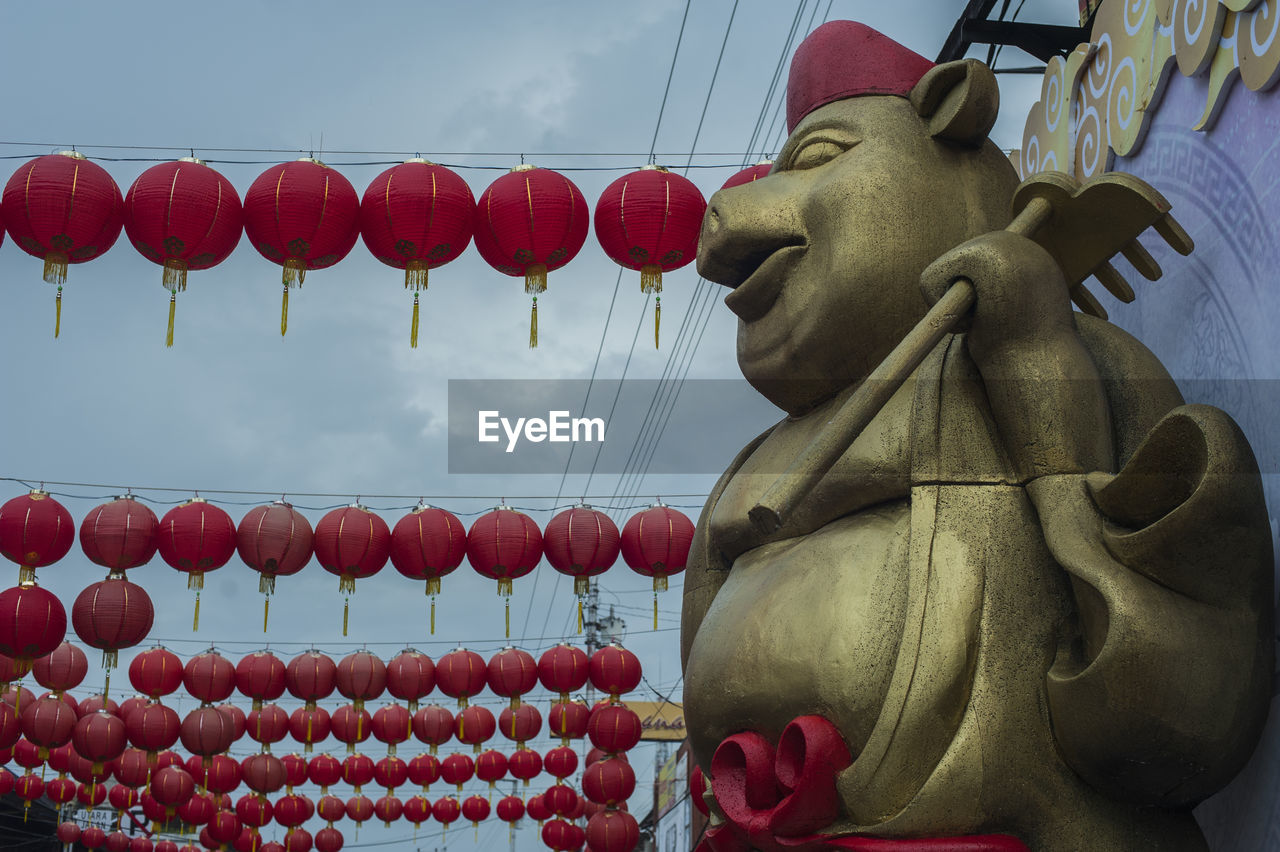 LOW ANGLE VIEW OF BUDDHA STATUE AGAINST SKY