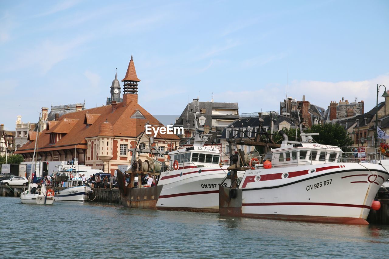 BOATS MOORED IN RIVER