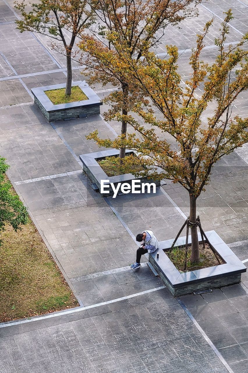 High angle view of man sitting on  a public place