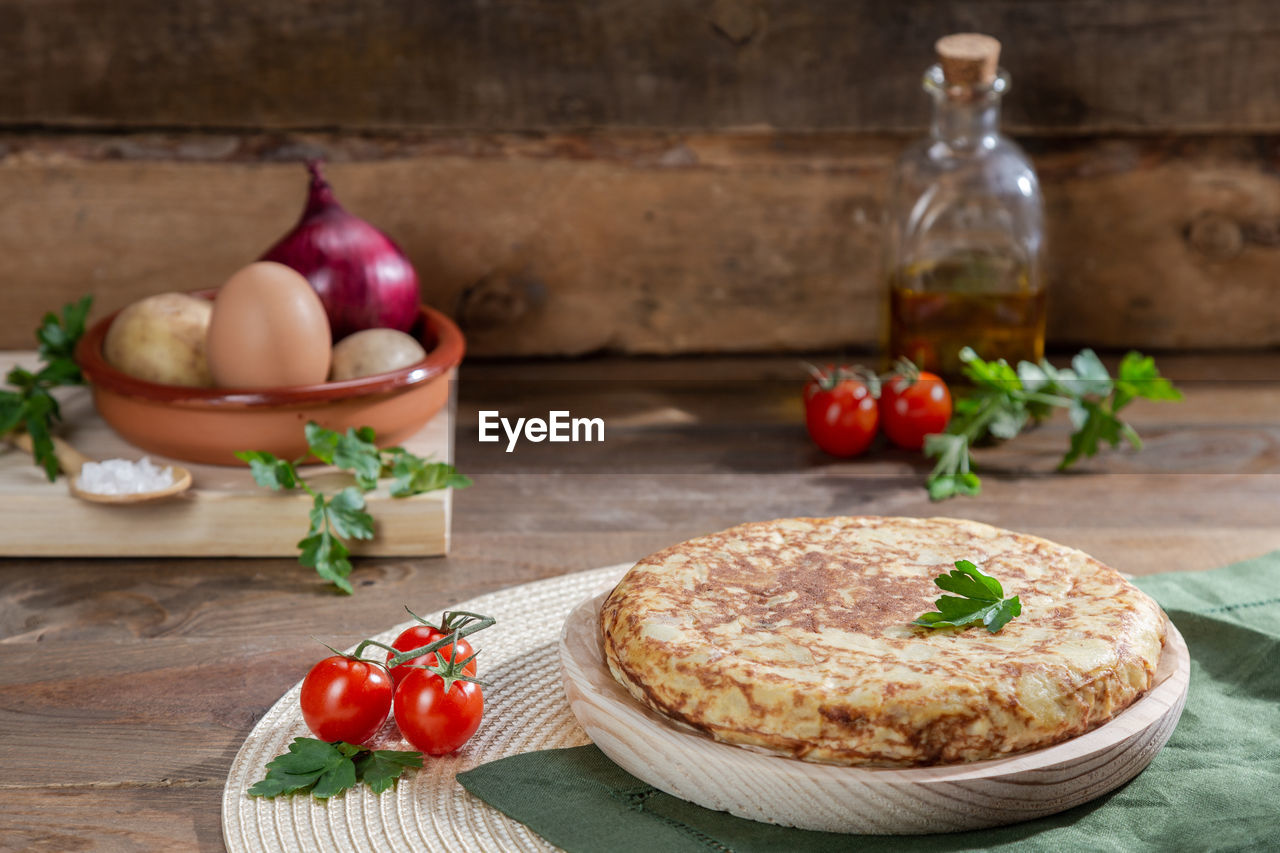 Traditional spanish omelette on wooden table.