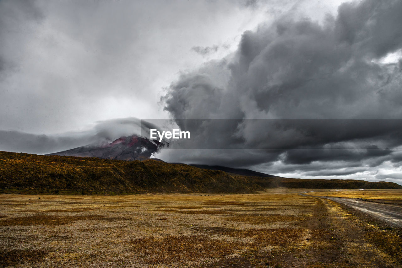 View of country road against cloudy sky