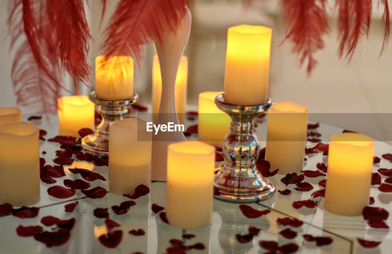 CLOSE-UP OF CANDLES ON TABLE