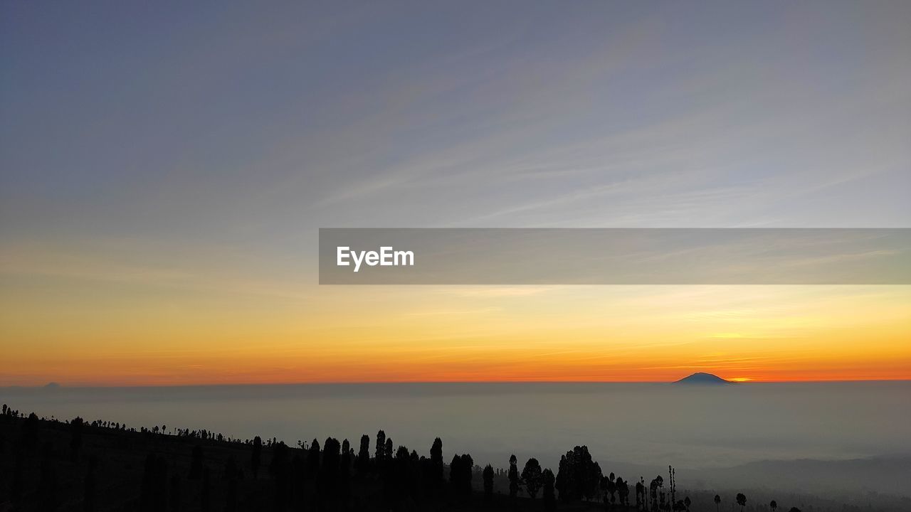 Scenic view of silhouette landscape against sky during sunset