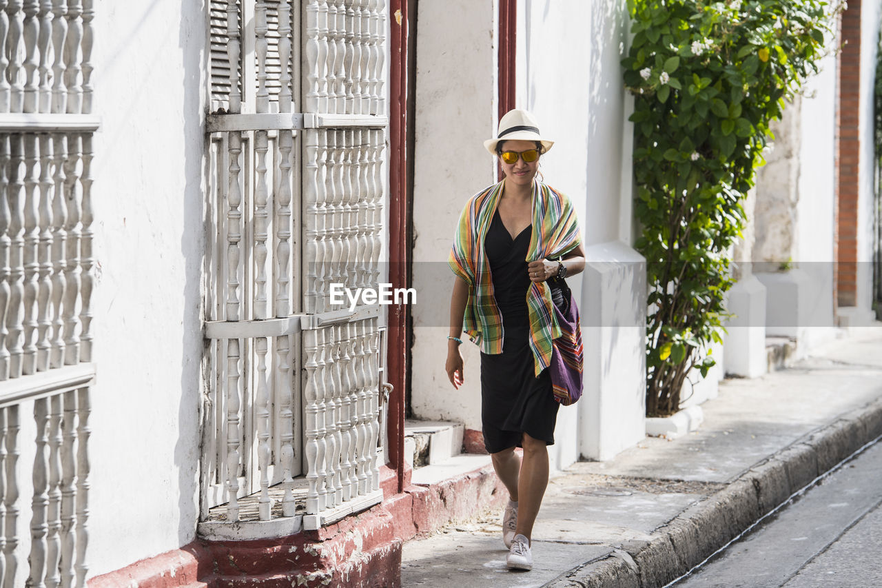 Woman exploring the streets of cartagena in columbia