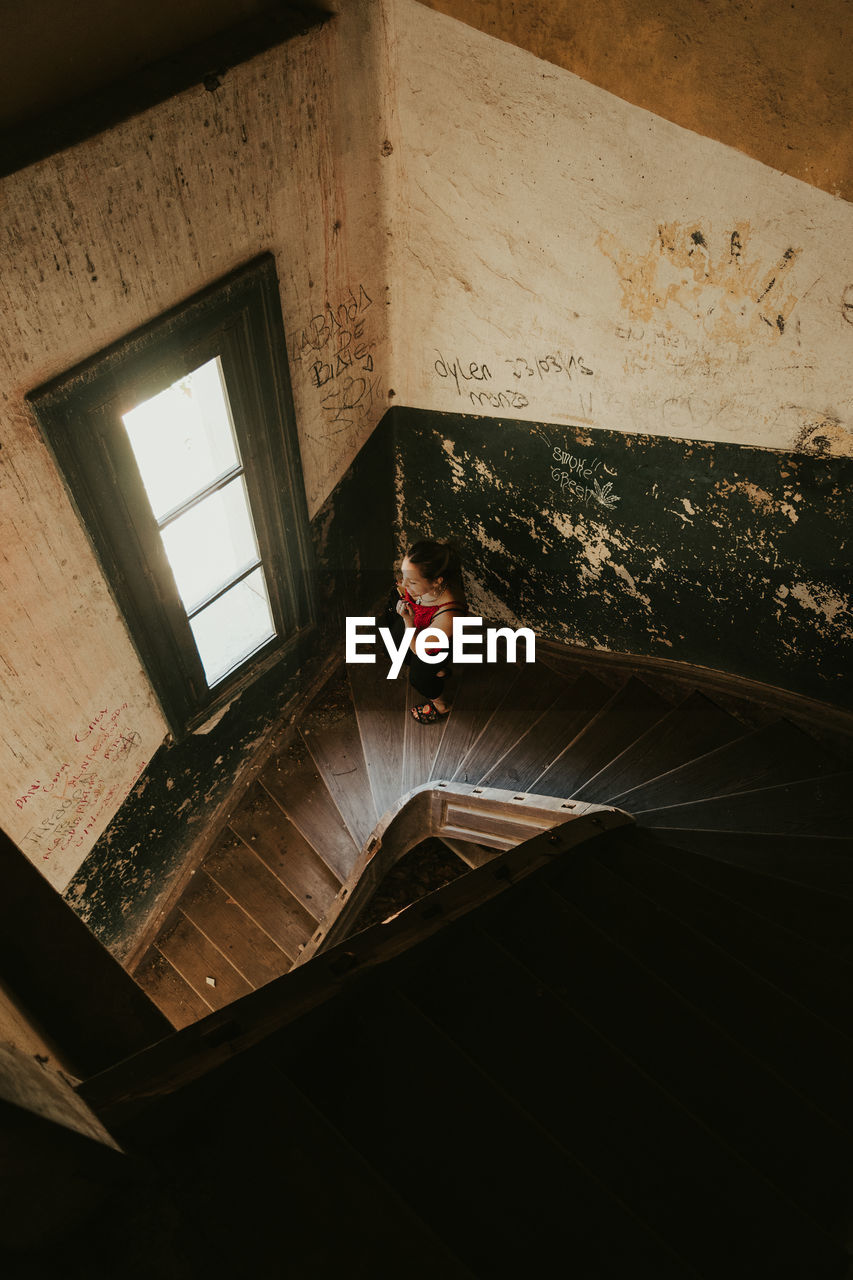 High angle view of woman walking on staircase