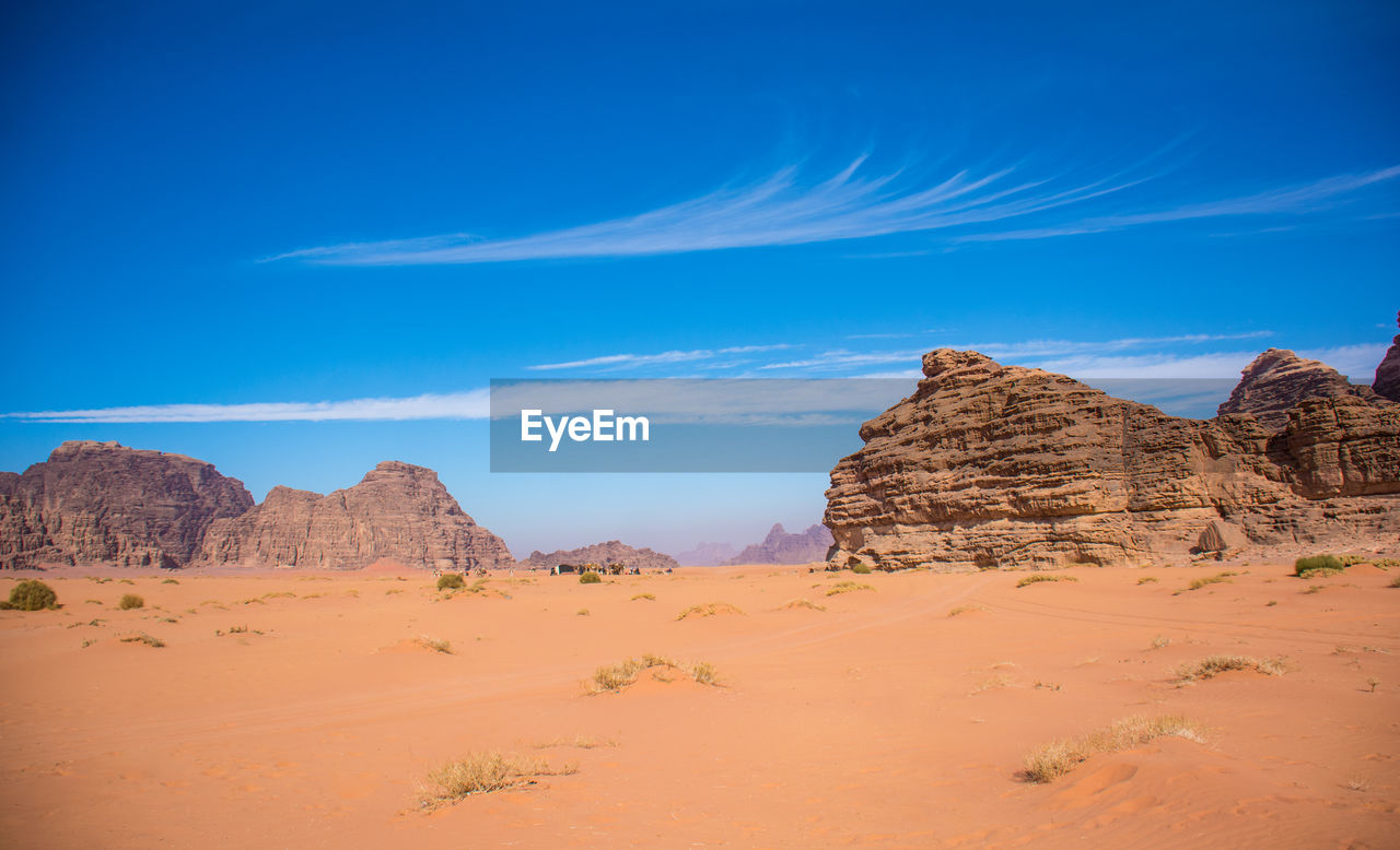 Scenic view of desert against blue sky