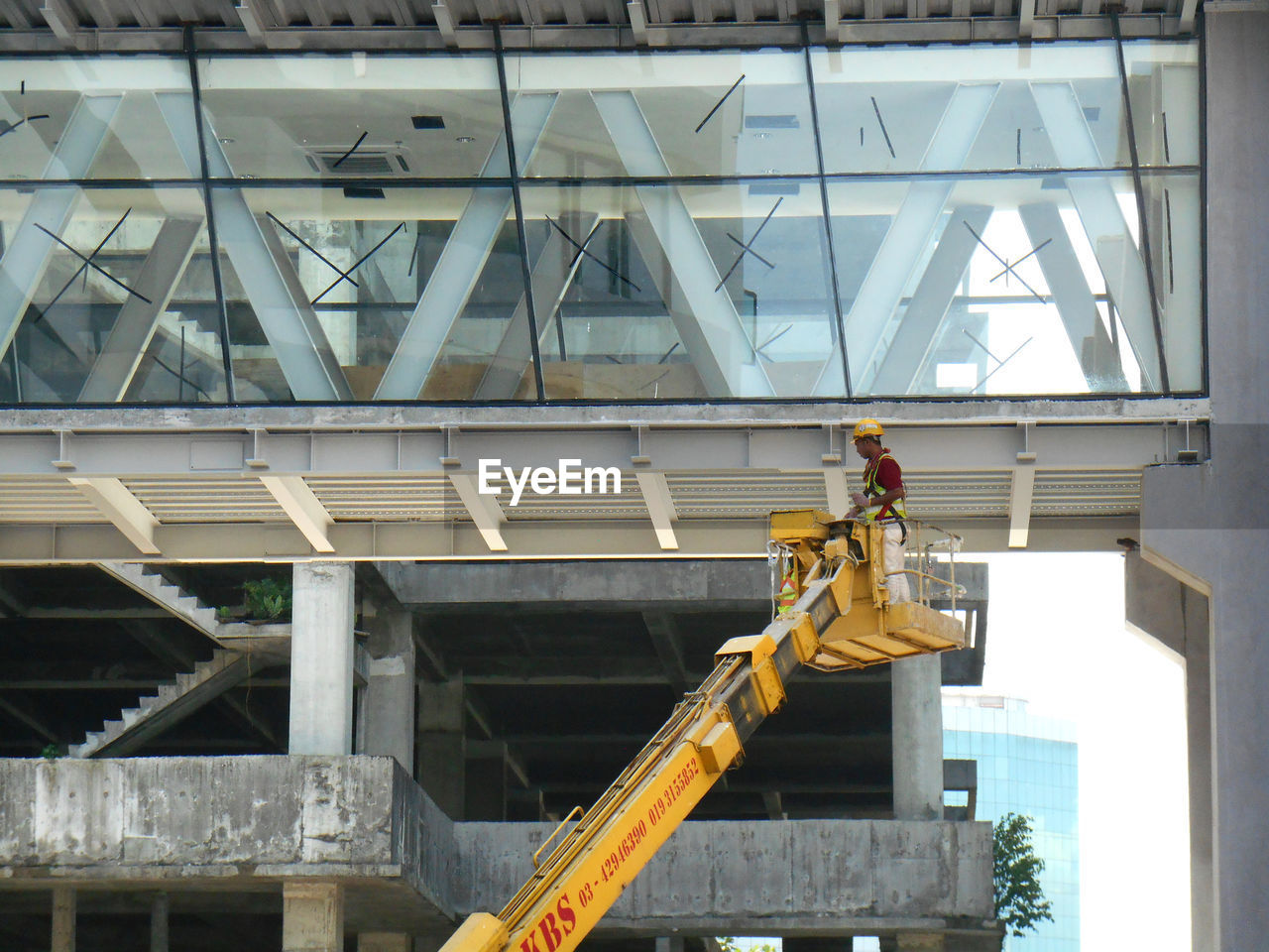 LOW ANGLE VIEW OF CONSTRUCTION WORKER AT SITE