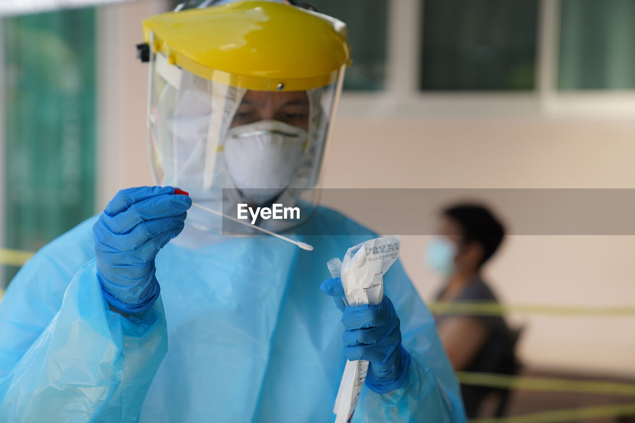 The doctors in  ppe protective suit congestion swab covid  the coronavirus covid-19 infection.