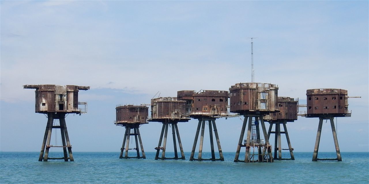 LIFEGUARD HUT ON SEA AGAINST SKY