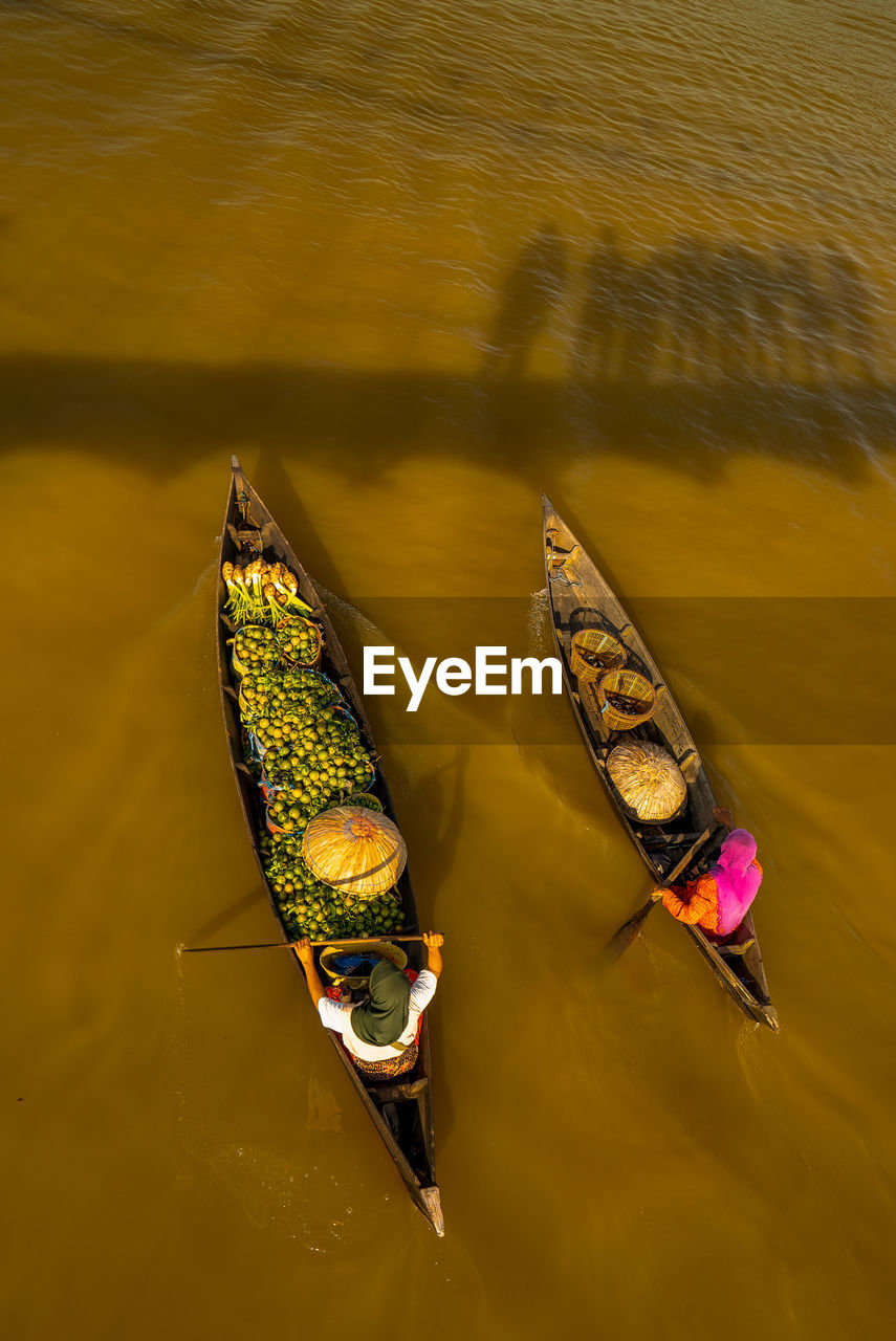 High angle view of people rowing boats on lake