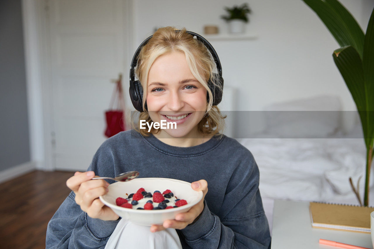 portrait of smiling young woman holding cake