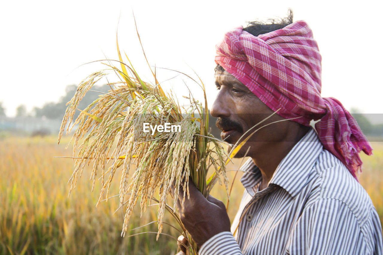 PORTRAIT OF SENIOR MAN ON FARM