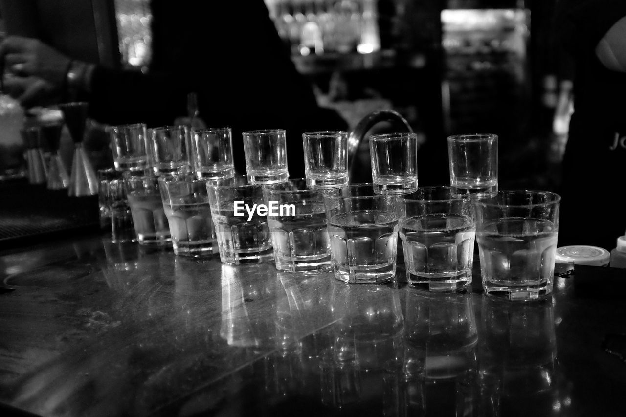Close-up of shot glasses on table