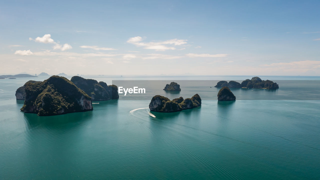 Aerial landscape view group islannd in middle sea and small speed boat tourist blue sky background 