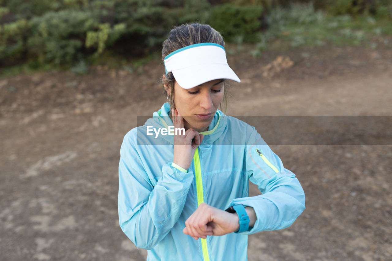 Woman checking pulse rate on smart watch