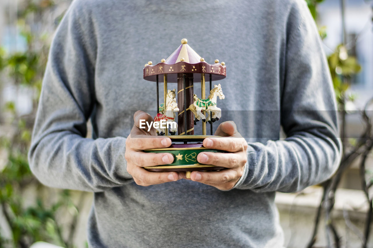 Close-up of a man holding his old toys 