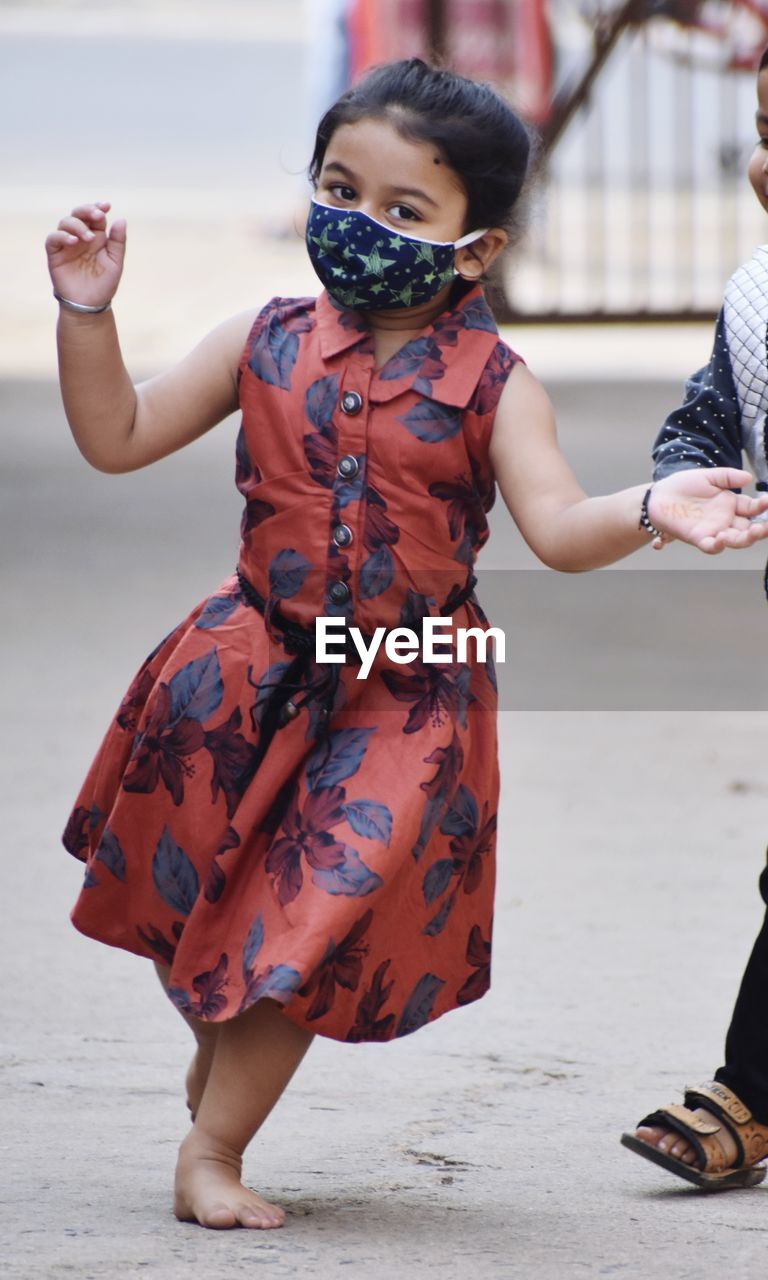 women, full length, clothing, fashion, childhood, child, spring, female, two people, adult, person, dress, costume, footwear, city, red, human face, architecture, emotion, togetherness, outdoors, street, standing, day, men, lifestyles, arts culture and entertainment, happiness