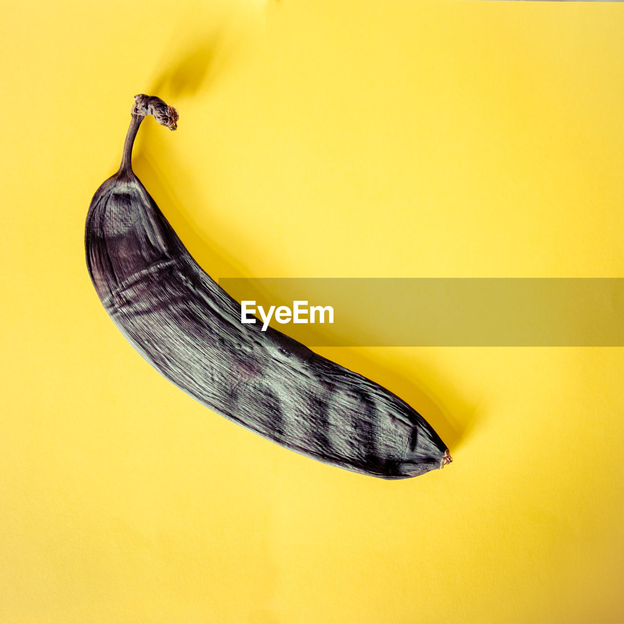 Close-up of a rotten banana on yellow background