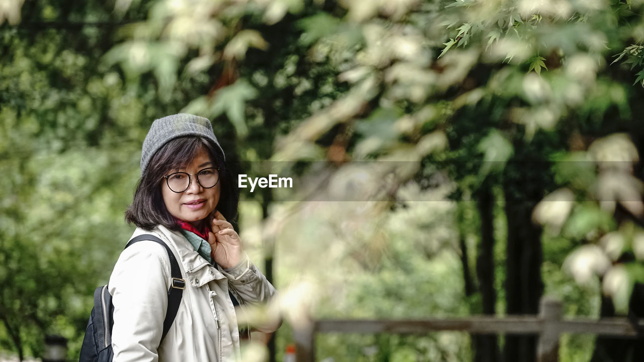 Portrait of young woman standing outdoors