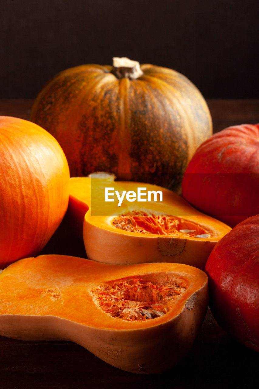 Different varieties of pumpkins on a dark background