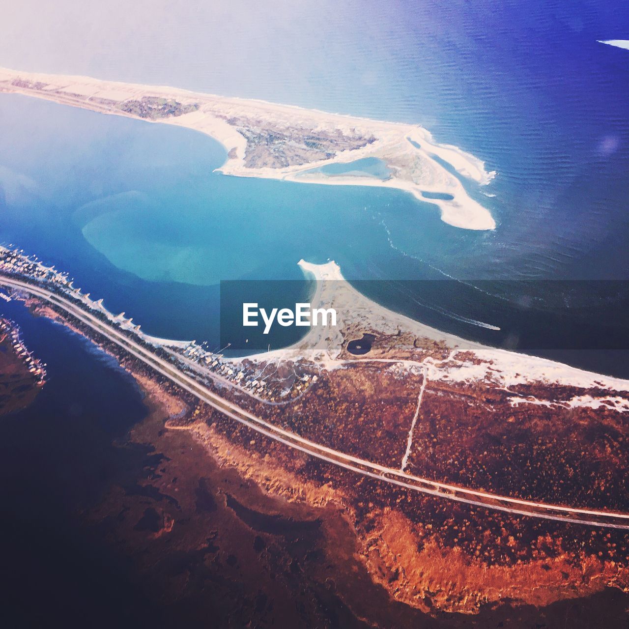 Aerial view of sea and mountains against sky