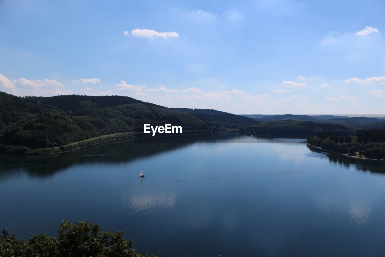 Scenic view of lake against cloudy sky