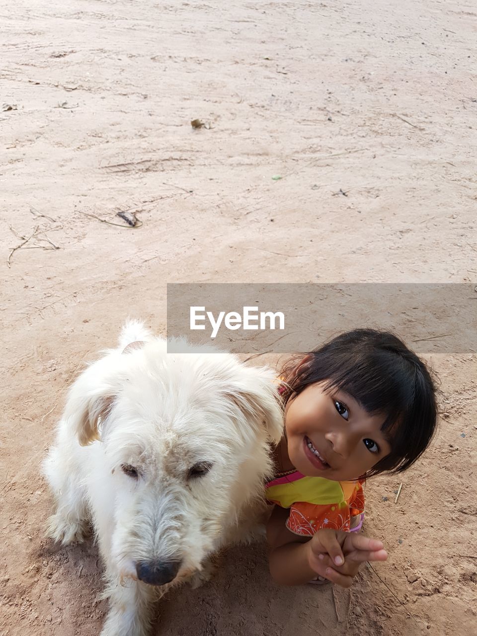 PORTRAIT OF WOMAN WITH DOG AGAINST WHITE