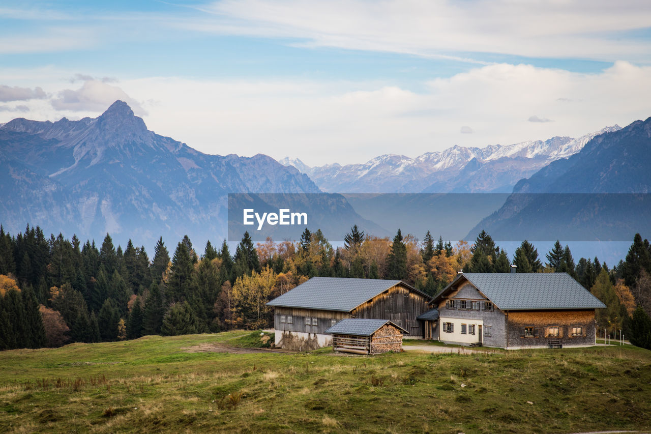 HOUSES AND MOUNTAINS AGAINST SKY