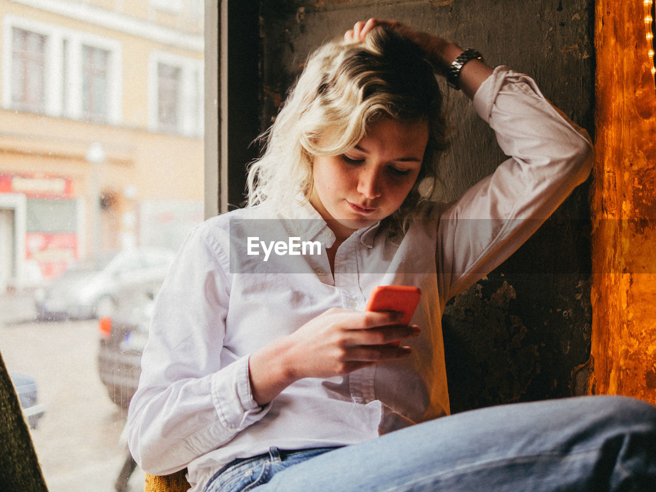 Front view of woman using mobile phone