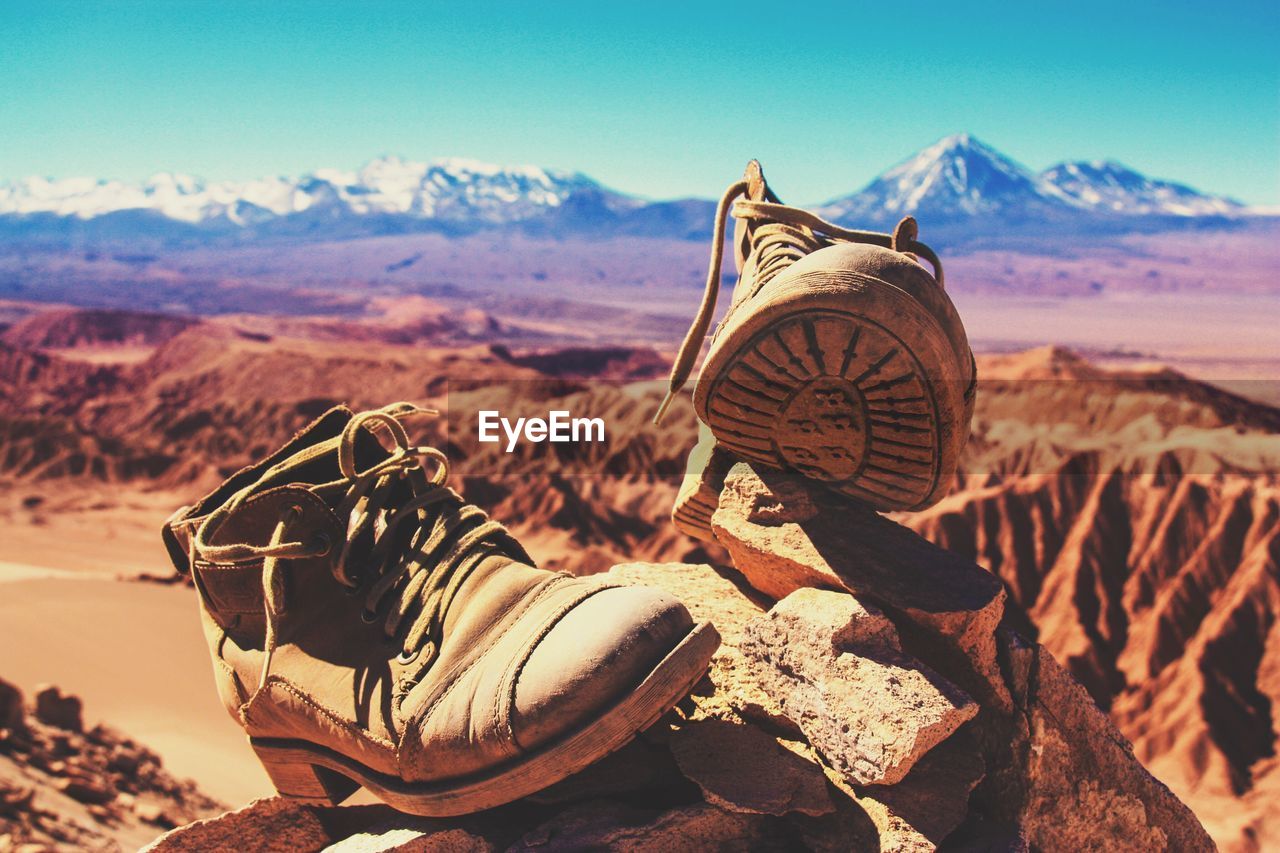 Close-up of boots on rock at atacama desert