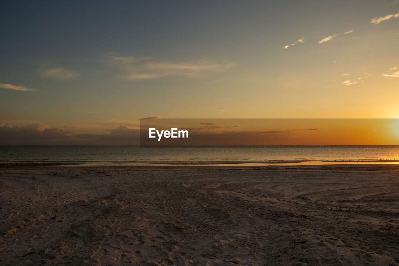 SCENIC VIEW OF BEACH DURING SUNSET