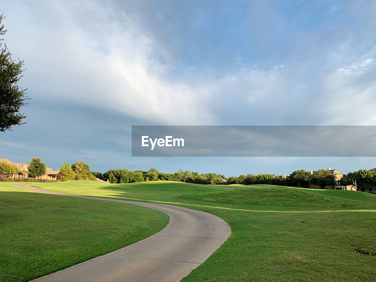 Scenic view of golf course against sky