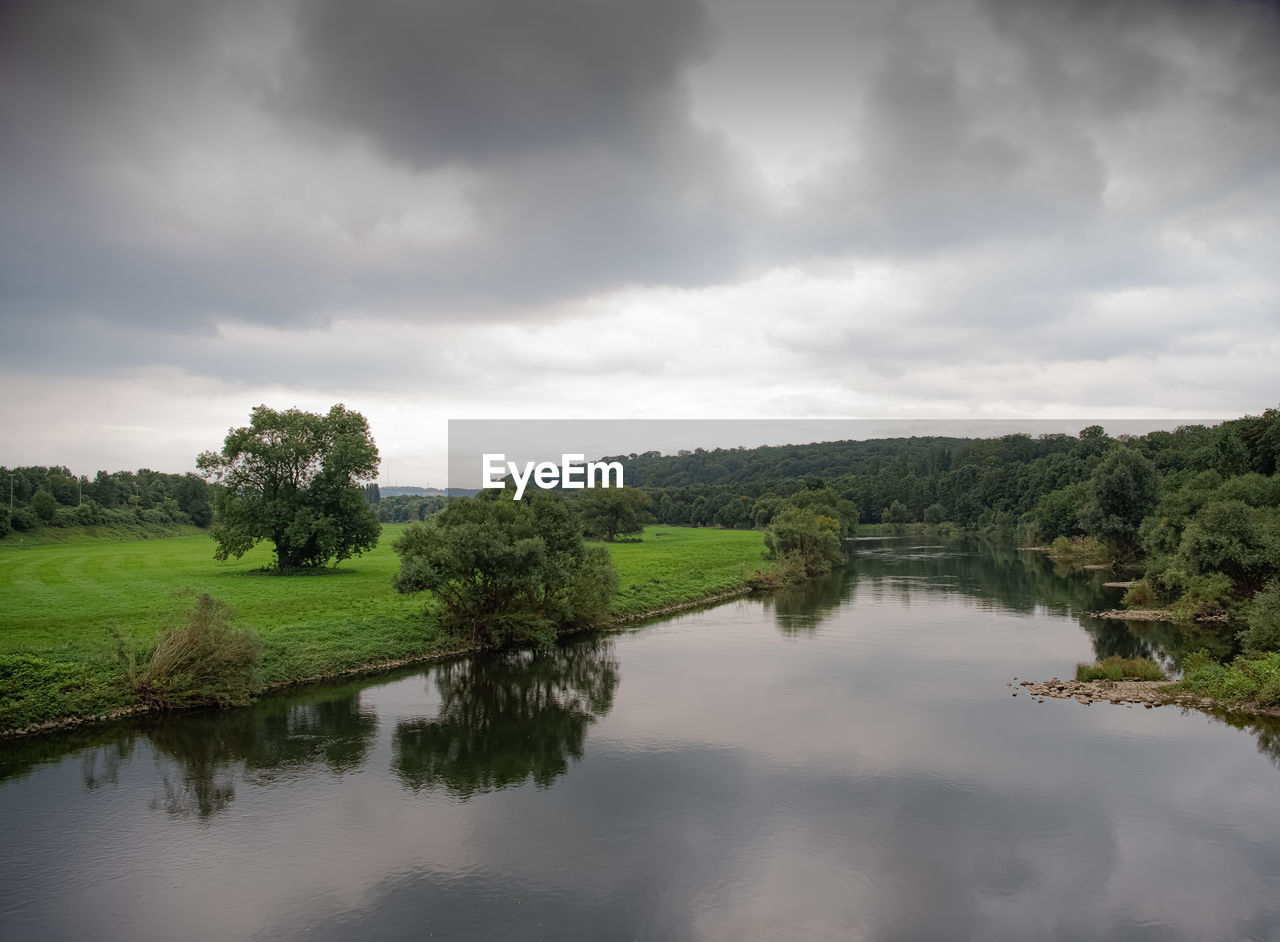 reflection, nature, water, cloud, sky, environment, tree, plant, landscape, scenics - nature, beauty in nature, lake, tranquility, overcast, land, no people, tranquil scene, reservoir, forest, outdoors, green, non-urban scene, grass, morning, travel destinations, rural scene, wetland, storm cloud, travel, storm, day, dramatic sky, rural area, tourism, wet