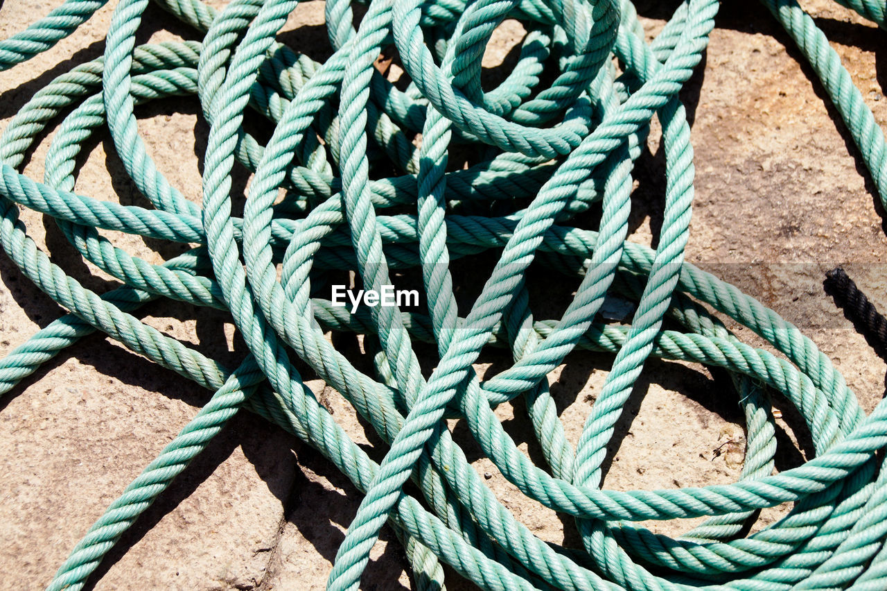 FULL FRAME SHOT OF ROPE TIED UP ON ROPES