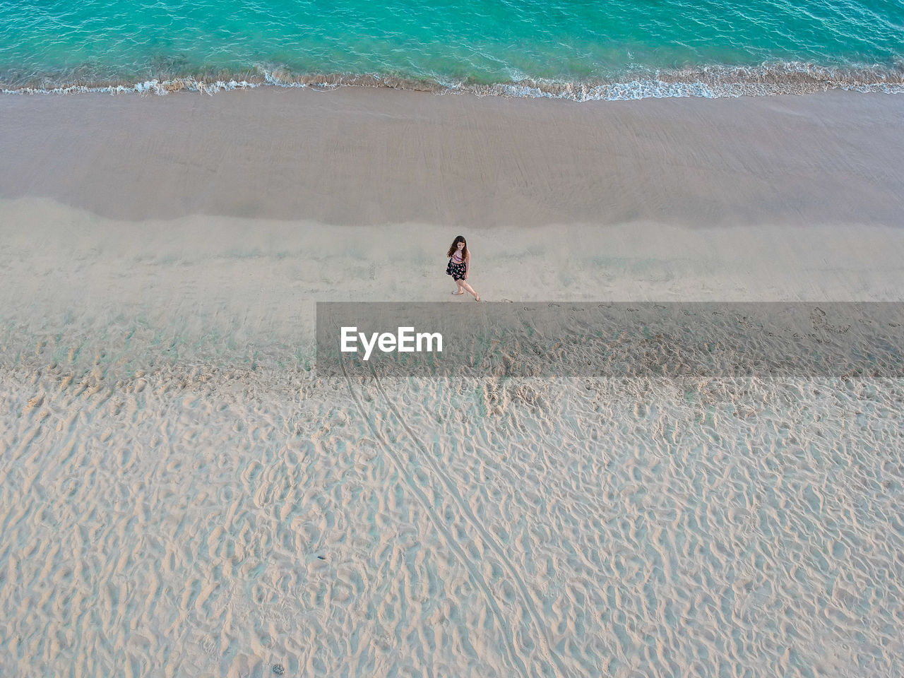 High angle view of woman standing at beach