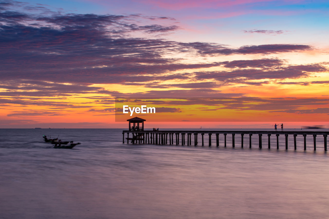 SILHOUETTE PIER ON SEA AGAINST SKY AT SUNSET